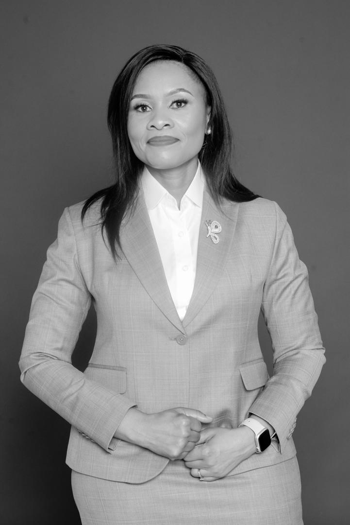 Priscillah Ndadi in a tailored suit, photographed in black and white